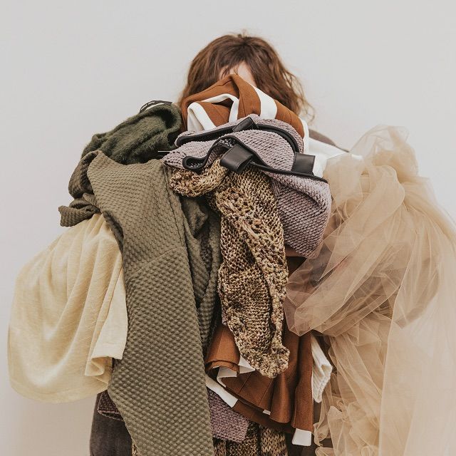 Woman holding a big bundle of clothes