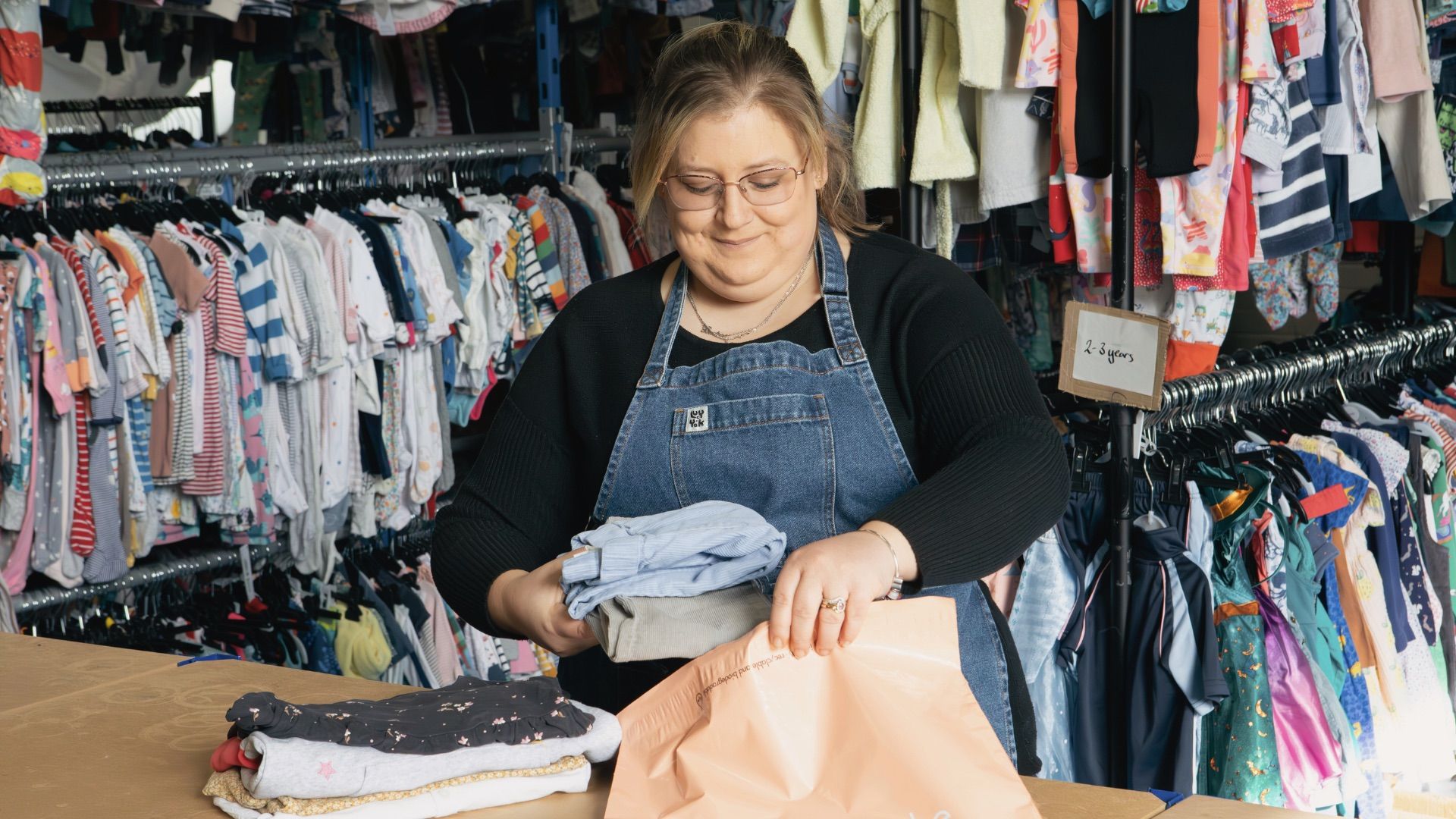 Woman packing clothes for shipping