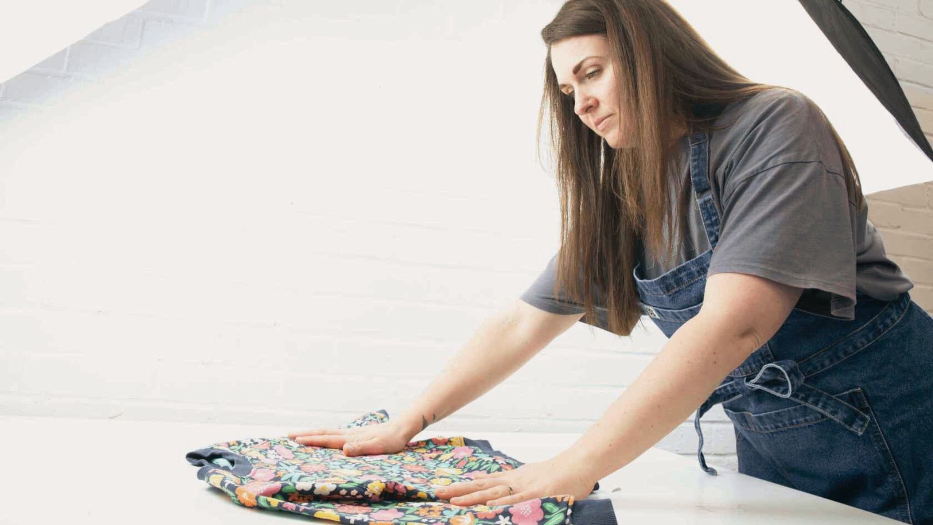 Woman photographing clothing items