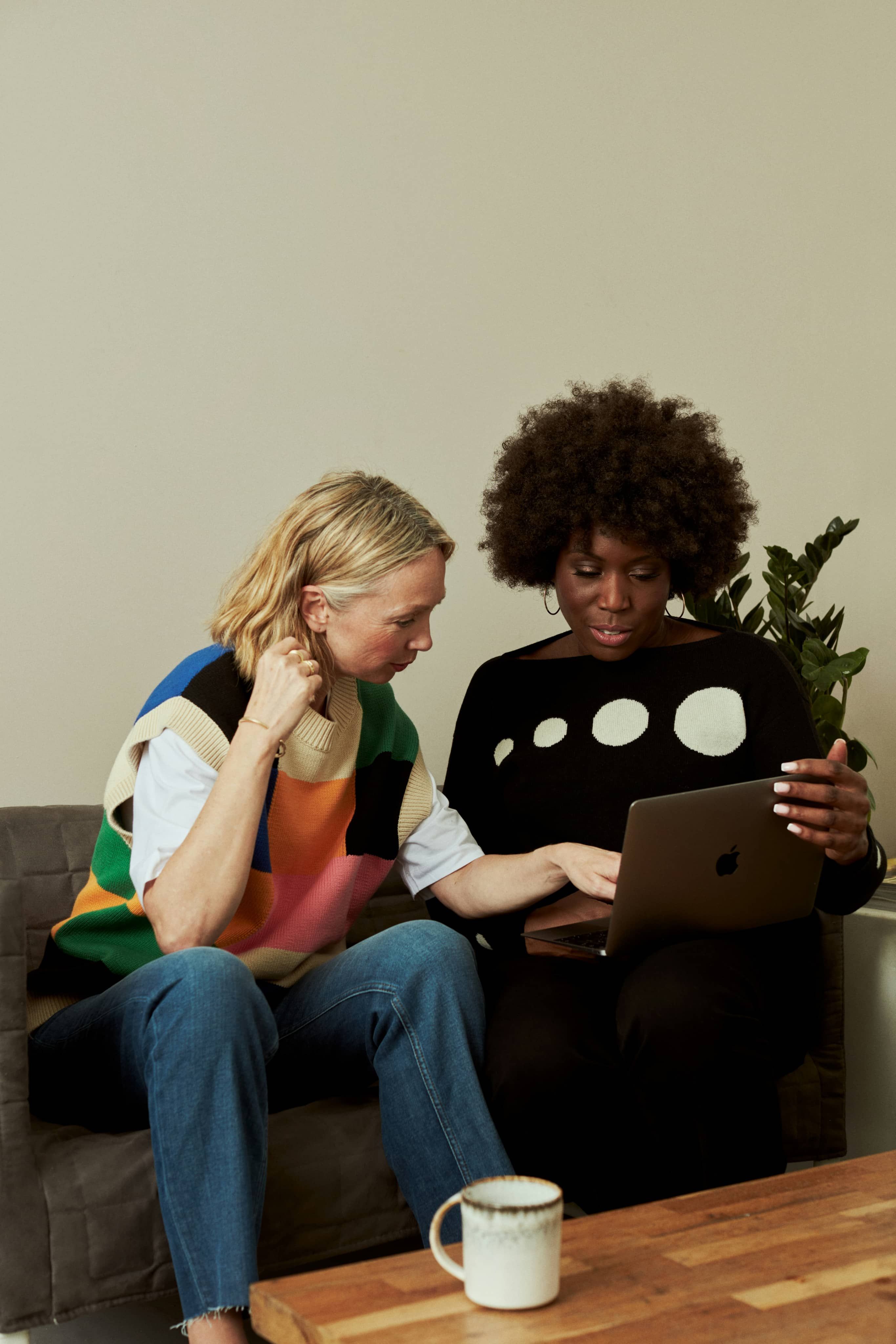Image of two people looking at the laptop